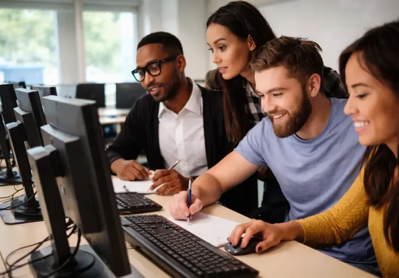 a group of computer science students working in the lab